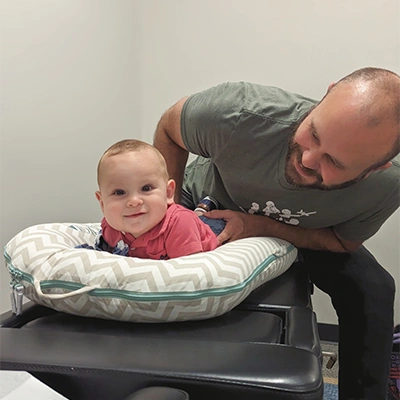 Chiropractor Cary NC Chris Hopkins Adjusting Pediatric Patient