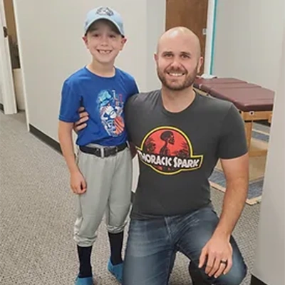 Chiropractor Cary NC Chris Hopkins With Happy Pediatric Patient